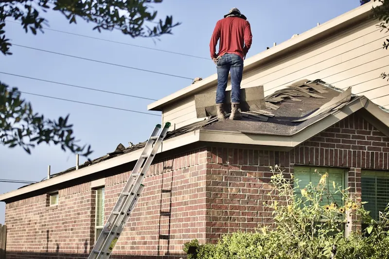 Professional roofer working on a residential roof in North Palm Beach Village